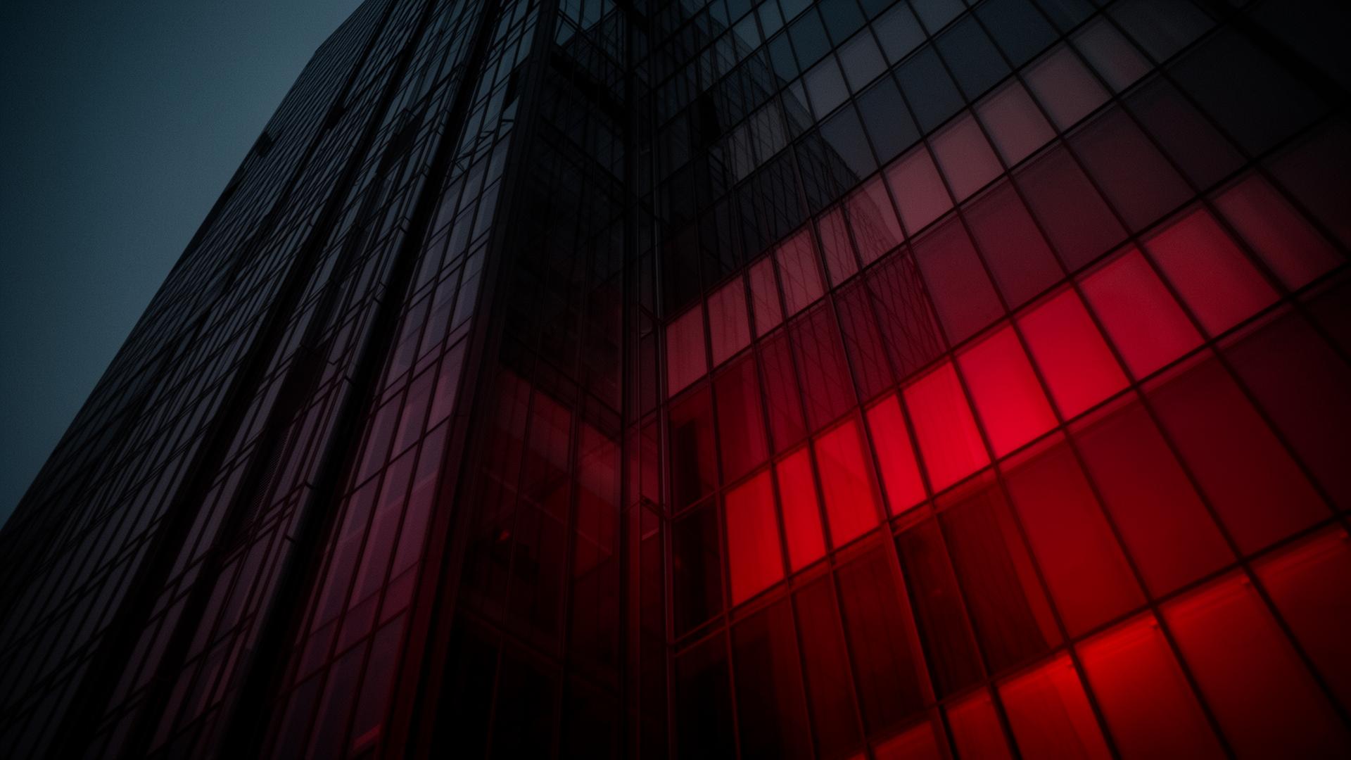 Modern glass skyscraper with red-tinted architectural window film